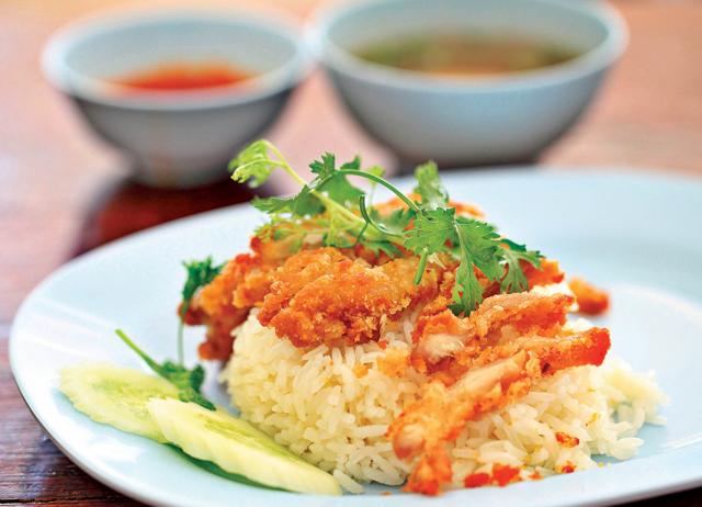 The Thai version of Khao Man Gai, Khao Man Tod, is spicier. Plus, they fry the chicken. (Shutterstock) The Thai version of Khao Man Gai, Khao Man Tod, is spicier. Plus, they fry the chicken. (Shutterstock)