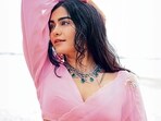 Adah Sharma is wearing a pink organza saree with a full-sleeve puff blouse and a statement diamond and emerald neckpiece from Naulakha Jewellers(Photo: Smriti Jha)