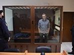 Russian opposition leader Alexei Navalny stands inside a glass cell during a court hearing at the Babushkinsky district court in Moscow on February 20, 2021.