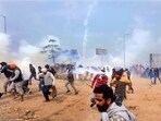 Farmers run for cover after police fired tear gas to disperse protesting farmers who were marching to New Delhi near the Punjab-Haryana border at Shambhu. Farmers run for cover after police fired tear gas to disperse protesting farmers who were marching to New Delhi near the Punjab-Haryana border at Shambhu.