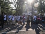 People stand in line to get visas at the embassy of Thailand in Yangon after Myanmar's military government said it would impose military service.