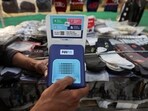 Paytm crisis: Cutlery vendor switches on Paytm, a digital payments firm, speaker to receive received payment details at a roadside market in Ahmedabad.