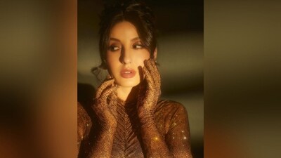 Assisted by makeup artist Reshmaa Merchant, Nora got decked up in shimmer eyeshadow, mascara coated lashes, darkened brows, blushed cheeks, dewy base, luminous highlighter and a shade of pink lipstick. (Instagram/@norafatehi)