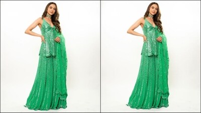 Her outfit comes in a luxurious georgette fabric and features a captivating green shade, plunging neckline peplum top adorned with exquisite mirror work detailing all over. She paired it with a matching sharara pants and a green netted scalloped dupatta. (Instagram/@rakulpreet) Her outfit comes in a luxurious georgette fabric and features a captivating green shade, plunging neckline peplum top adorned with exquisite mirror work detailing all over. She paired it with a matching sharara pants and a green netted scalloped dupatta. (Instagram/@rakulpreet)