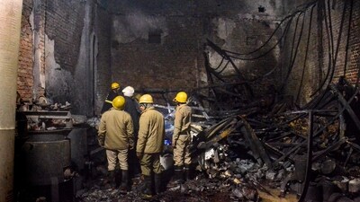 Fire brigade personnel look on after dousing a late fire at a paint factory in the Alipur area in northern New Delhi on Feb.16. (AP) Fire brigade personnel look on after dousing a late fire at a paint factory in the Alipur area in northern New Delhi on Feb.16. (AP)