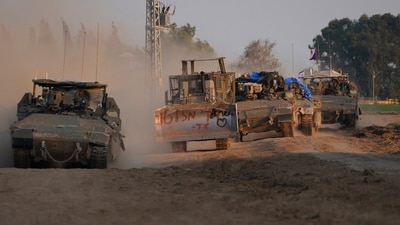 Israel-Hamas War: A column of armored Israeli army vehicles drives in southern Israel near the Gaza border. (AP) Israel-Hamas War: A column of armored Israeli army vehicles drives in southern Israel near the Gaza border. (AP)