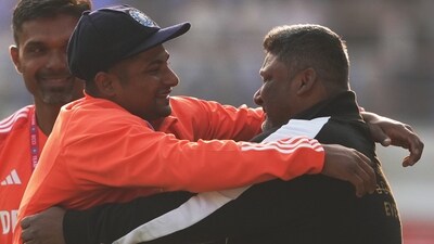 Sarfaraz Khan hugs his father Naushad Khan after receiving his India Test cap (PTI) Sarfaraz Khan hugs his father Naushad Khan after receiving his India Test cap (PTI)