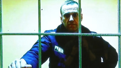 Russian opposition leader Alexei Navalny is seen on a screen via video link from the IK-2 corrective penal colony in Pokrov in May 2022. (Reuters)