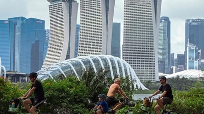 People cycle along Marina Bay East Park, past the Marina Bay Sands resort, in Singapore. (AFP)