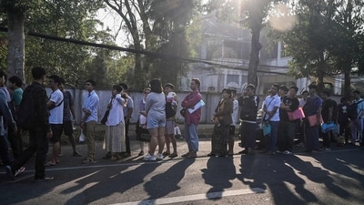 People stand in line to get visas at the embassy of Thailand in Yangon after Myanmar's military government said it would impose military service. (AFP) People stand in line to get visas at the embassy of Thailand in Yangon after Myanmar's military government said it would impose military service. (AFP)
