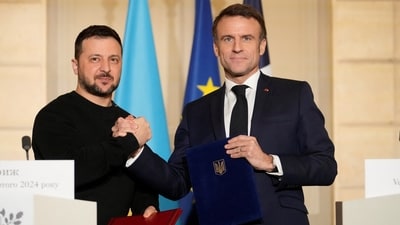 French President Emmanuel Macron and his Ukrainian counterpart Volodymyr Zelenskiy shake hands after signing an agreement, February 16, 2024 at the Elysee Palace in Paris, France. (via Reuters)