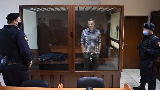 Russian opposition leader Alexei Navalny stands inside a glass cell during a court hearing at the Babushkinsky district court in Moscow on February 20, 2021. (AFP)