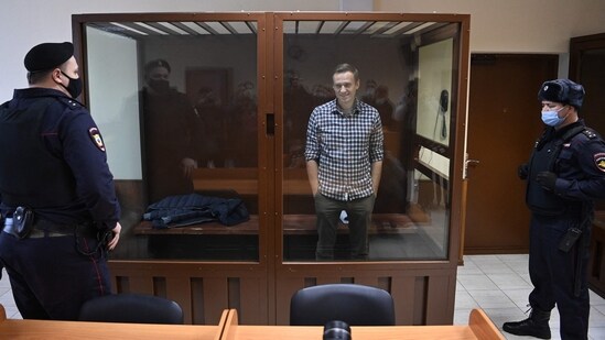Russian opposition leader Alexei Navalny stands inside a glass cell during a court hearing at the Babushkinsky district court in Moscow on February 20, 2021. (AFP)