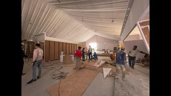 Men at work at the exhibition venue of GBC 4.0 venue in Lucknow on Friday (HT)
