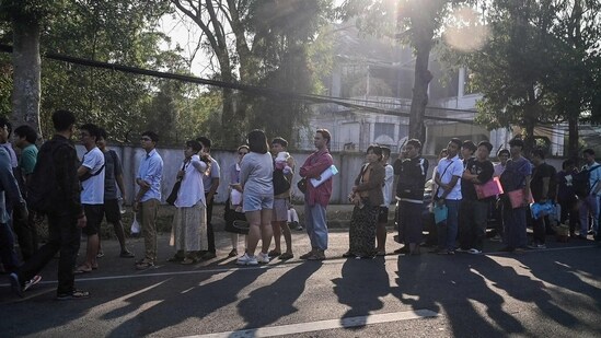 People stand in line to get visas at the embassy of Thailand in Yangon after Myanmar's military government said it would impose military service. (AFP)