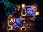 Photos of jailed Russian opposition leader Alexei Navalny with flowers and candles are laid on a ground in front of the Russian embassy in Vilnius, Lithuania, on Feb. 16.