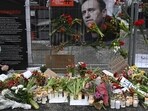 Candles and flowers are brought to a makeshift memorial.
