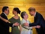 Squamish Nation Councillor Wilson Williams, left; Meghan Markle; Chief of the Tsleil-Waututh Nation, Jen Thomas; and Prince Harry exchange greetings after being given blankets during the "One Year to Go" Invictus Games dinner in Vancouver, British Columbia, Friday, Feb. 16, 2024. (Ethan Cairns/The Canadian Press via AP)