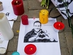 Candles surround a portrait of Alexei Navalny at Russian embassy in Chisinau on February 17, 2024, one day after Russian officials announced the death of the Kremlin's most prominent critic. Russian officials announced the 47-year-old had died on February 16 in an Arctic prison, a month before an election poised to extend President Vladimir Putin's hold on power. (Photo by Elena COVALENCO / AFP)
