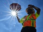 TOPSHOT - Traffic warden Rai Rogers mans his street corner during an 8-hour shift under the hot sun in Las Vegas, Nevada on July 12, 2023, where temperatures reached 106 degrees amid an ongoing heatwaves. (Photo by Frederic J. BROWN / AFP)(AFP)