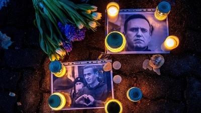 Photos of jailed Russian opposition leader Alexei Navalny with flowers and candles are laid on a ground in front of the Russian embassy in Vilnius, Lithuania, on Feb. 16. (AP) Photos of jailed Russian opposition leader Alexei Navalny with flowers and candles are laid on a ground in front of the Russian embassy in Vilnius, Lithuania, on Feb. 16. (AP)
