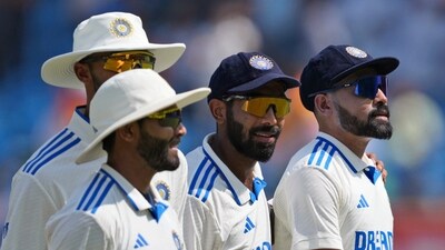 India's Mohammed Siraj, right, leaves the field with Jasprit Bumrah, second right, and other teammates at the end of England's first innings in Rajkot (AP) India's Mohammed Siraj, right, leaves the field with Jasprit Bumrah, second right, and other teammates at the end of England's first innings in Rajkot (AP)