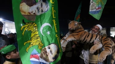 Pakistan Elections 2024: Supporters of Pakistan's former prime minister Nawaz Sharif's party 'Pakistan Muslim League-N, celebrate victory of a candidate of their party in the parliamentary elections, in Peshawar. (AP) Pakistan Elections 2024: Supporters of Pakistan's former prime minister Nawaz Sharif's party 'Pakistan Muslim League-N, celebrate victory of a candidate of their party in the parliamentary elections, in Peshawar. (AP)