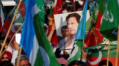 A portrait of the former Prime Minister Imran Khan is seen amid flags of Pakistan Tehreek-e-Insaf (PTI) and the religious and political party Jamat-e-Islami (JI) as supporters attend a joint protest in Karachi on February 10. (Reuters)