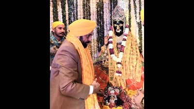 Punjab chief minister Bhagwant Mann praying for peace, progress and prosperity of people at Baglamukhi Dham in Pakhowal, Ludhiana, on Saturday. (HT Photo)