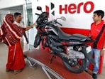 Customers look at a Hero MotoCorp Karizma motorbike at a Hero MotoCorp showroom in the western Indian city of Ahmedabad