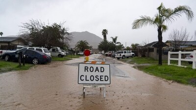 A road closure sign on a flooded road during a storm in Fontana, California, US. (Bloomberg)