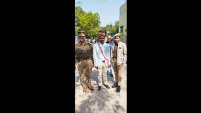 Prashant Namdev, a police constable aspirant, at an exam centre in his groom avatar in Mahoba on Sunday. (Sourced)