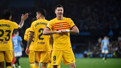 Barcelona's Polish forward Robert Lewandowski celebrates scoring his team's first goal during the Spanish league football match between RC Celta de Vigo and FC Barcelona (AFP) Barcelona's Polish forward Robert Lewandowski celebrates scoring his team's first goal during the Spanish league football match between RC Celta de Vigo and FC Barcelona (AFP)