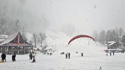 Tourists enjoy skiing in the snow-covered Solang Valley, Himachal.yy (ANI)