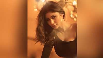 She styled her luscious tresses into soft curls and left them open at the centre, cascading beautifully down her shoulders and perfectly complementing her stunning look. (Instagram/@imouniroy) She styled her luscious tresses into soft curls and left them open at the centre, cascading beautifully down her shoulders and perfectly complementing her stunning look. (Instagram/@imouniroy)