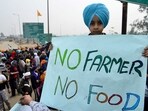 A boy holds a placard during a protest by farmers to demand minimum crop prices, near the Haryana-Punjab state border at Shambhu in Patiala district. A boy holds a placard during a protest by farmers to demand minimum crop prices, near the Haryana-Punjab state border at Shambhu in Patiala district.
