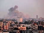 A picture taken from Rafah shows smoke billowing over Khan Yunis in the southern Gaza Strip during Israeli bombardment.