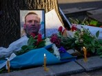 A portrait of opposition leader Alexei Navalny and flowers are seen during a protest in front of Russian embassy in Belgrade, Serbia.
