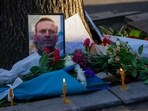 A portrait of opposition leader Alexei Navalny and flowers are seen during a protest in front of Russian embassy in Belgrade, Serbia.
