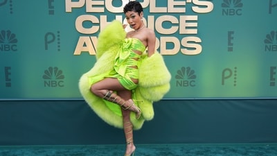 Coi Leray wore a neon green mini dress adorned with cut-outs on the side, a large bow on the front, and shimmering sequins. She paired the strapless bodycon ensemble with an oversized neon green fur coat draped on her shoulder. Lastly, neon green high heels, a diamond choker with a heart pendant, stacked earrings, her short bob styled in curls, shimmering green eye shadow, mascara-adorned lashes, and on-fleek brows rounded it all off. (Jordan Strauss/Invision/AP) Coi Leray wore a neon green mini dress adorned with cut-outs on the side, a large bow on the front, and shimmering sequins. She paired the strapless bodycon ensemble with an oversized neon green fur coat draped on her shoulder. Lastly, neon green high heels, a diamond choker with a heart pendant, stacked earrings, her short bob styled in curls, shimmering green eye shadow, mascara-adorned lashes, and on-fleek brows rounded it all off. (Jordan Strauss/Invision/AP)