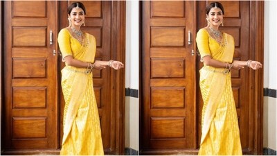 Pooja's saree is crafted from a luxurious Banarasi fabric and comes in a rich shade of golden yellow. With an intricate meenakari shikargha weave, this piece truly represents elegance beyond the ordinary. She draped the saree in the traditional way around her waist, with the pallu falling elegantly from her shoulders. (Instagram/@hegdepooja) Pooja's saree is crafted from a luxurious Banarasi fabric and comes in a rich shade of golden yellow. With an intricate meenakari shikargha weave, this piece truly represents elegance beyond the ordinary. She draped the saree in the traditional way around her waist, with the pallu falling elegantly from her shoulders. (Instagram/@hegdepooja)