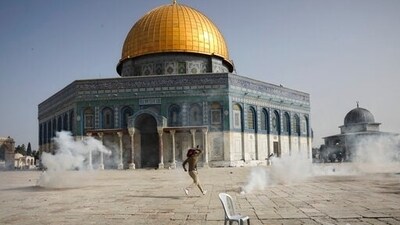 Palestinian man runs away from tear gas during clashes with Israeli security forces in the Al Aqsa Mosque compound in Jerusalem's Old City. (AP) Palestinian man runs away from tear gas during clashes with Israeli security forces in the Al Aqsa Mosque compound in Jerusalem's Old City. (AP)