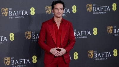 Andrew Scott gave the boring old tuxedo a fashionable spin on the red carpet in a striking deep red notch lapel blazer, matching silk shirt, and high-waisted pants. He styled the fitted ensemble with matching dress shoes.&nbsp; (REUTERS)