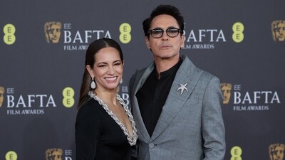Robert Downey Jr. and his wife Susan pose at the red carpet. Downey won Best Supporting Actor for Oppenheimer. (REUTERS)