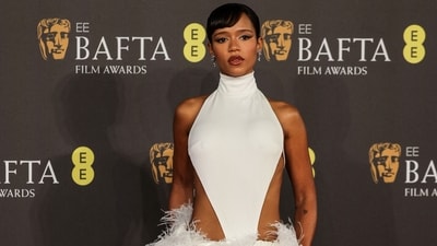 Taylor Russell wore a dramatic white feathered gown with a high neckline, cut-out detail, and feathered adornments on the waist and floor-sweeping train to attend the BAFTA Awards. The dress is from Loewe and she styled it with dramatic Tiffany & Co earrings. (AFP) Taylor Russell wore a dramatic white feathered gown with a high neckline, cut-out detail, and feathered adornments on the waist and floor-sweeping train to attend the BAFTA Awards. The dress is from Loewe and she styled it with dramatic Tiffany & Co earrings. (AFP)