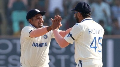 India's Rohit Sharma celebrates a wicket with Sarfaraz Khan during the 3rd Test (REUTERS)
