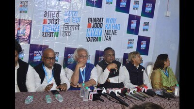 Congress leader Jairam Ramesh (in blue jacket) and other party leaders addressing media in Pratapgarh on Feb 19. (HT photo)