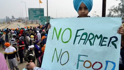 A boy holds a placard during a protest by farmers to demand minimum crop prices, near the Haryana-Punjab state border at Shambhu in Patiala district. (AFP) A boy holds a placard during a protest by farmers to demand minimum crop prices, near the Haryana-Punjab state border at Shambhu in Patiala district. (AFP)