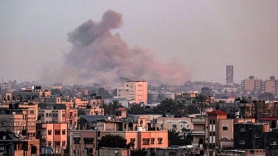 A picture taken from Rafah shows smoke billowing over Khan Yunis in the southern Gaza Strip during Israeli bombardment. (AFP)