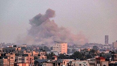 A picture taken from Rafah shows smoke billowing over Khan Yunis in the southern Gaza Strip during Israeli bombardment. (AFP)